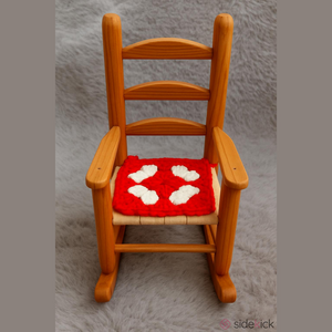 Handmade wooden rocking chair with crocheted seat cushion